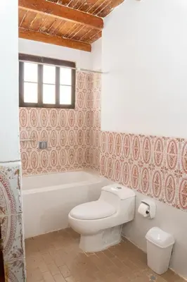 a bathroom with a toilet and a tub and a sink at HAWKA in Ica