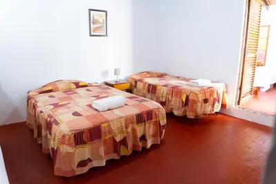 a room with two beds in a room at HAWKA in Ica
