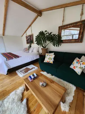 a living room with a green couch and a table at Spirit Of The River Lodge in Cusco