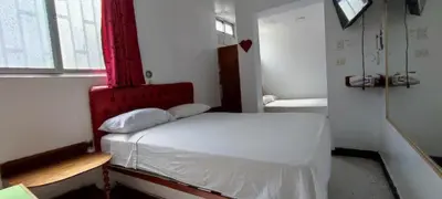 a small room with a bed and a window at Hostal Reyna in Lima