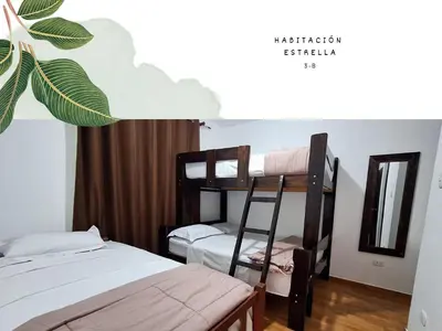 a bedroom with two bunk beds and a mirror at Casa Vacacional Puro Jita in Lunahuaná