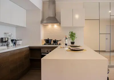 a kitchen with white cabinets and a white counter top at Apartamento de estreno en Miraflores Gym/Piscina in Lima