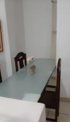 a dining room table with two chairs and a white table at Peruvian Apartment in Lima