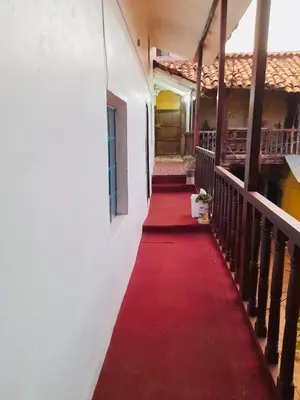 a red carpet walks down a hallway of a building at Washichay in Cusco