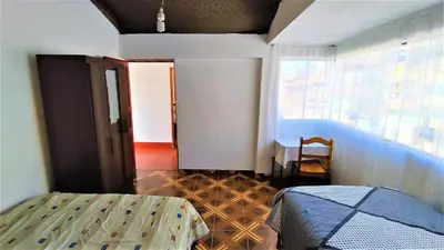 a bedroom with a bed and a window and a table at APARTAMENTO VISTA IMPERIAL II Mirador Panoramico in Cusco