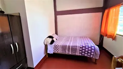 a small bedroom with a bed in a room at APARTAMENTO VISTA IMPERIAL II Mirador Panoramico in Cusco