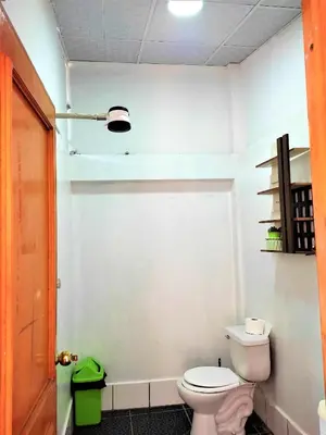 a bathroom with a white toilet in a room at APARTAMENTO VISTA IMPERIAL II Mirador Panoramico in Cusco
