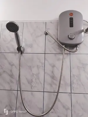 a shower with a shower head on a wall at Warmisitay HOME individual in Lima