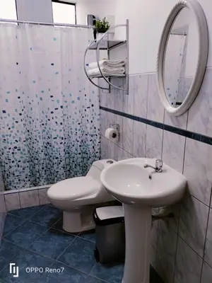 a bathroom with a sink and a toilet and a mirror at Warmisitay HOME individual in Lima