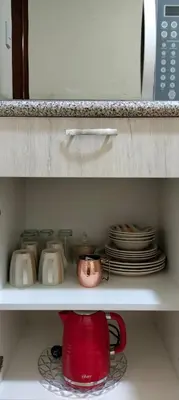 a red tea pot and plates on a shelf at Warmisitay HOME individual in Lima
