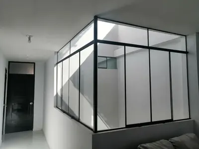 a large glass wall in a room with a couch at Alemar's House in Nazca