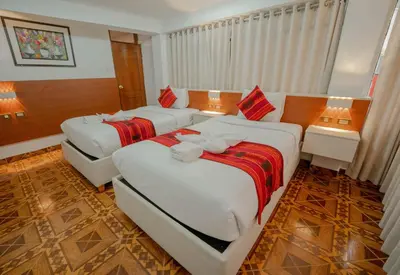 a hotel room with two beds in a room at DANNA INN in Machu Picchu