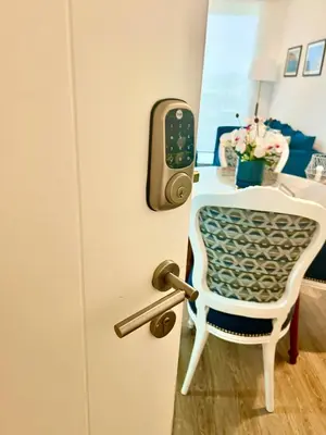 a door with a table and a chair in a room at Depa playa San Bartolo 3 camas piscina wifi juegos in Lima