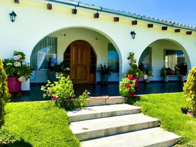 a house with a garden and a door at Fundo Alma Andina in Jauja
