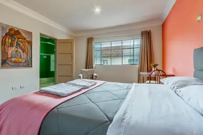 a bedroom with a large bed and a window at Templo de la Luna in Cusco