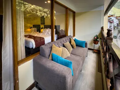 a living room with a couch and a bed at Santuario Machupicchu in Machu Picchu