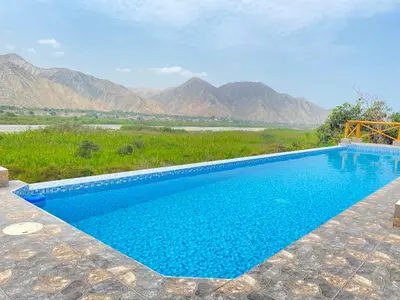 a swimming pool with a view of mountains at Mirador del Paraiso in Lunahuaná