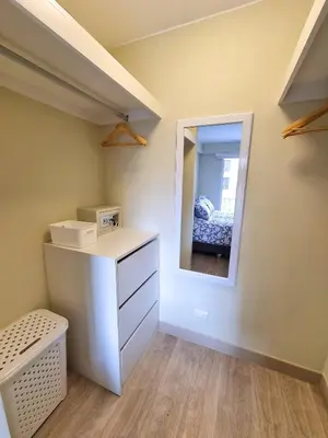 a bedroom with a vanity and a mirror and a bed at Hermoso y céntrico 1BR en Barranco con cochera wifi y netflix in Lima