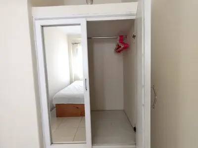 a small room with a mirror and a bed at LA CASA DE LA ABUELA in Barranca