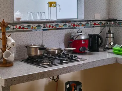 a kitchen counter with pots and pans on a stove at LA CASA DE LA ABUELA in Barranca
