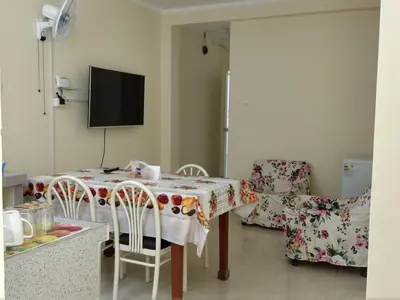 a kitchen with a table and chairs and a television at LA CASA DE LA ABUELA in Barranca