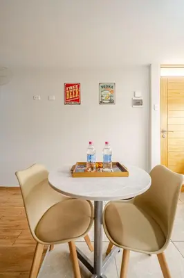 a white table with two bottles of water on it at Acogedor Loft equipado con Sofá cama en Matellini in Lima