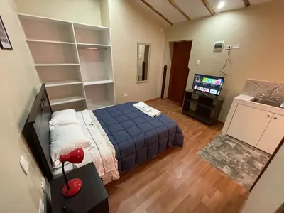 a small room with a bed and a television at Anka Wasi Lodging in Cusco