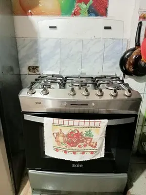 a stove top oven sitting in a kitchen at POSADA ISABELITA in Lima