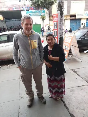 a man and a woman standing on a sidewalk at POSADA CHABELITA in Lima