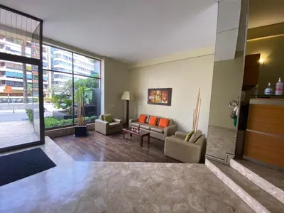 a living room with couches and a large window at APARTAMENTO COMPLETO EN LA MEJOR ZONA DE MIRAFLORES in Lima