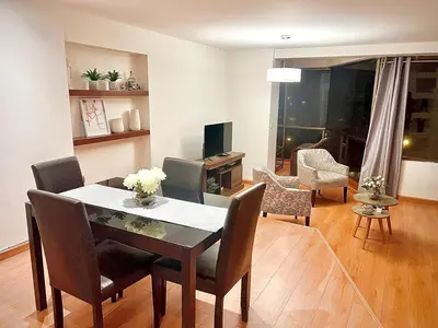 a living room with a dining room table and chairs at APARTAMENTO COMPLETO EN LA MEJOR ZONA DE MIRAFLORES in Lima