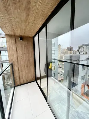 a room with glass and wood walls and a balcony at Departamento amoblado in Lima
