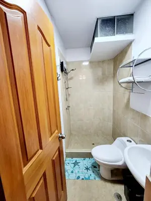a bathroom with a toilet and a sink and a shower at Departamento familiar en Huacachina in Ica