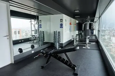 a gym with a chair and a view of a city at Beautiful cozy Apt Barranco / Miraflores Peru in Lima