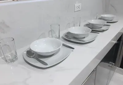 a white counter with bowls and glasses on it at APARTAMENTO LINDO - A 2 Cuadras de la Plaza de Armas y del Palacio de Gobierno in Lima