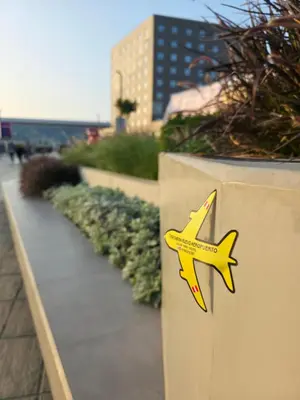 a yellow airplane on the side of a wall at Sabina aeropuerto hostel in Lima