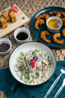 a table with a plate of food and a plate of onion rings at Hotel California Urubamba in Urubamba