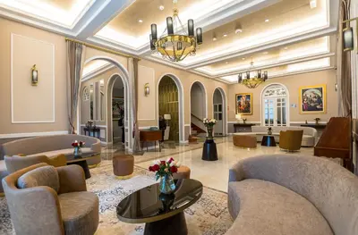 a lobby with chairs and tables and a chandelier at Hotel de Turistas Huancayo - Hotel Asociado Casa Andina in Huancayo