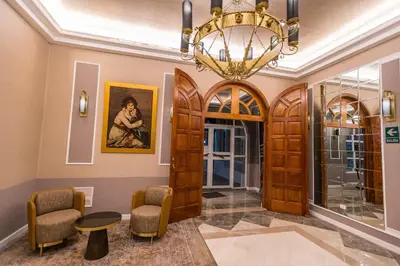 a lobby with a chandelier and chairs and a table at Hotel de Turistas Huancayo - Hotel Asociado Casa Andina in Huancayo