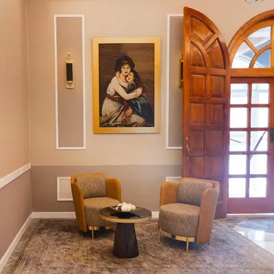 a room with a painting of a woman holding a child at Hotel de Turistas Huancayo - Hotel Asociado Casa Andina in Huancayo