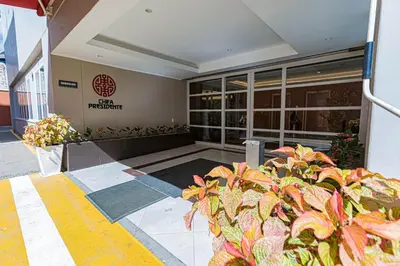 a building with a plant in front of it at Hotel Presidente Huancayo - Asociado Casa Andina in Huancayo