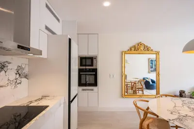 a kitchen with a table and a mirror on the wall at * Casma Residence * Private Terrace & Grill & HVAC in Lima