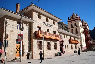 a man is standing in front of a building at Hotel Presidente Huancavelica - Asociado Casa Andina in Huancavelica