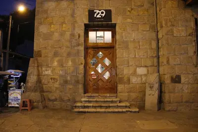 a brick building with a door with the number at Hotel Presidente Huancavelica - Asociado Casa Andina in Huancavelica