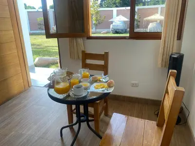 a table with breakfast foods and orange juice on it at HOTEL HACIENDA SUBTANJALLA CASABLANCA in Ica