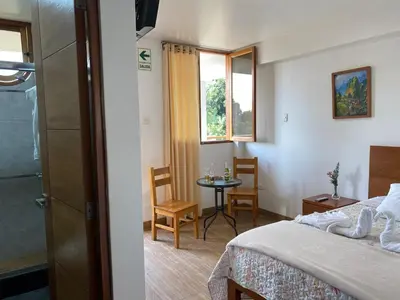 a hotel room with a bed and a small table at HOTEL HACIENDA SUBTANJALLA CASABLANCA in Ica