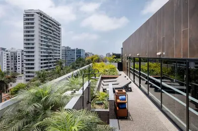 a balcony of a building with trees and plants at Doubletree By Hilton Lima San Isidro in Lima