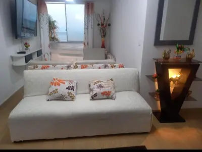 a living room with a couch with three pillows at lindo departamento Frente al mar in Lima