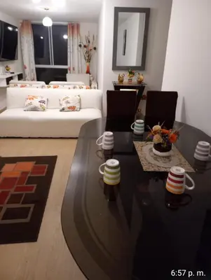 a living room with a white couch and a table at lindo departamento Frente al mar in Lima