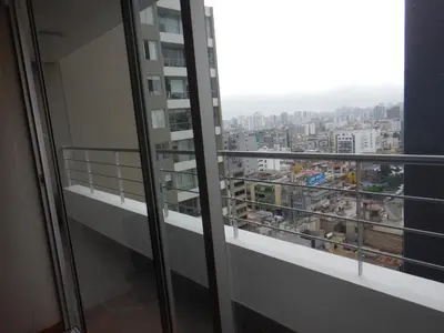 a balcony with a view of a city at Apartment near to MIRAFLORES, BEACHES & REBAGLIATI HOSPITAL ! Panoramic View,Pool, Gym,Private Park in LINCE in Lima